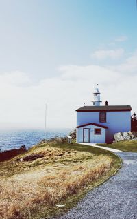 Lighthouse against cloudy sky