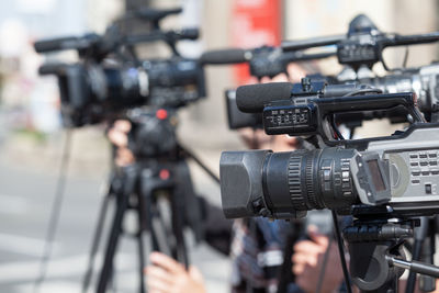 Cropped image of people photographing through camera