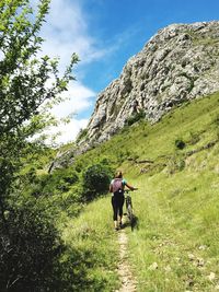 Rear view of man walking on trail