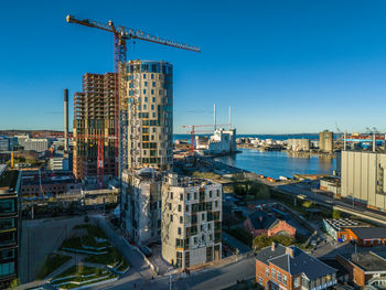 High angle view of cityscape against clear blue sky