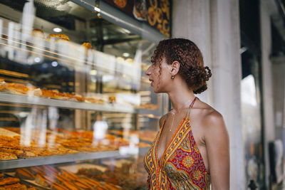 Side view of young woman looking away