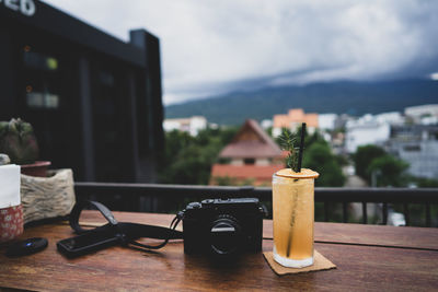 Close-up of wine bottles on table against sky