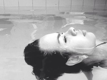 Side view of woman swimming in pool