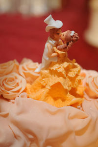 Close-up of figurines on wedding cake