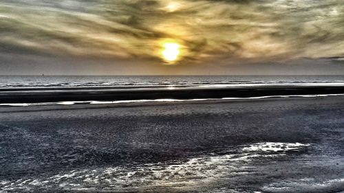 Scenic view of beach against sky during sunset