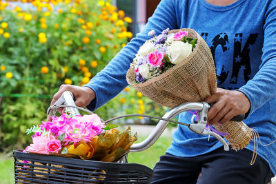 Midsection of man holding ice cream in basket