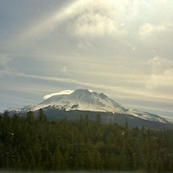 Scenic view of snowcapped mountains against cloudy sky