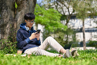 Young man sitting on field