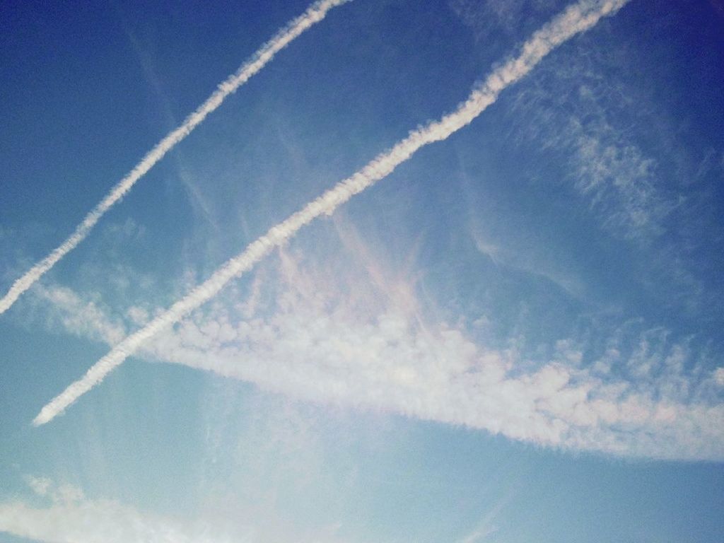 blue, low angle view, sky, vapor trail, cloud - sky, beauty in nature, scenics, nature, tranquility, flying, tranquil scene, sky only, outdoors, airplane, day, no people, cloud, idyllic, backgrounds, aerial view