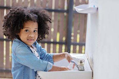 Portrait of smiling boy in bathroom at home