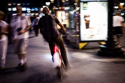 Woman looking at illuminated city at night