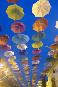 Low angle view of multi colored umbrella on wall
