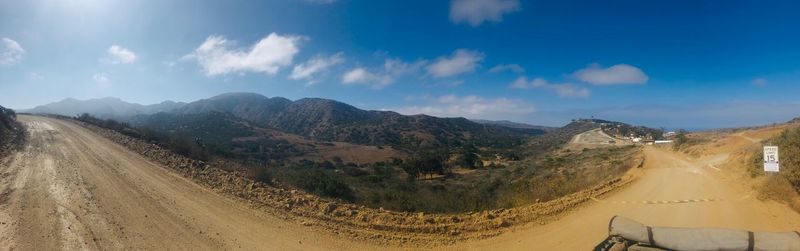 Panoramic view of road amidst mountains against sky