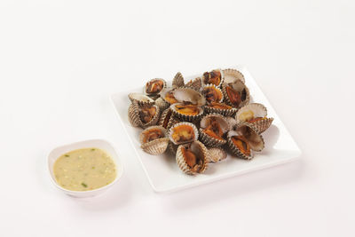 High angle view of food in plate against white background