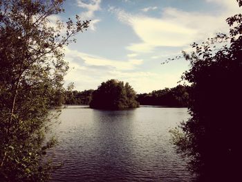 Scenic view of lake against cloudy sky