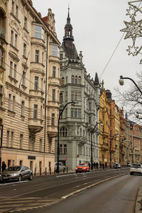 Traffic on road against buildings in city