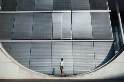 Businessman standing outside modern building