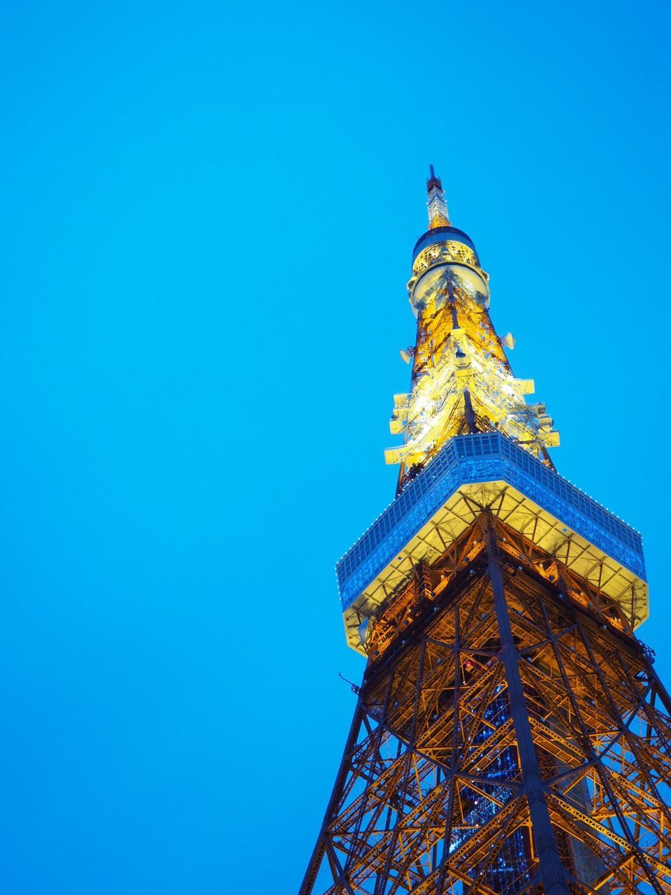 low angle view, blue, copy space, clear sky, built structure, architecture, tower, tall - high, building exterior, travel destinations, spire, tourism, culture, outdoors, skyscraper, day, famous place, international landmark, high section, no people, national landmark, modern, capital cities, city life, blue color