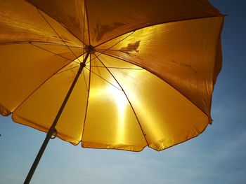 View of yellow umbrella against sky in the sun