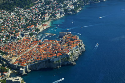 High angle view of townscape by sea