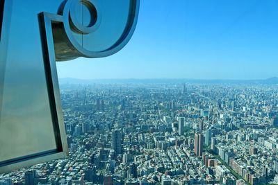 High angle view of illuminated city buildings against clear sky