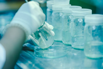The scientist's hands pouring solvent into the bottles