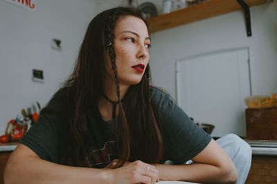 Sad woman with the cigarette at home