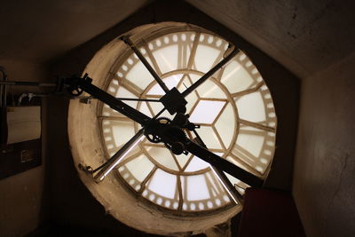 Low angle view of clock on window in old building