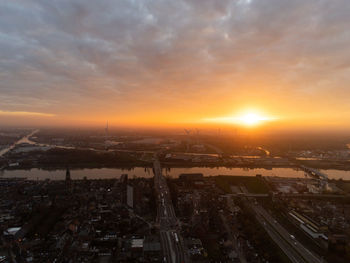 High angle view of city against sky during sunset