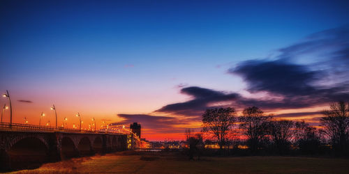 Silhouette bridge against sky during sunset