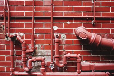 Fire hydrant against brick wall