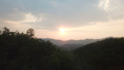 Scenic view of mountains against sky at sunset