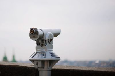 Close-up of coin-operated binoculars against sky