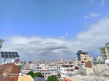 Buildings in town against blue sky