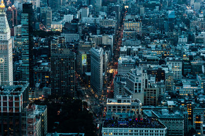 High angle view of illuminated city buildings at dusk