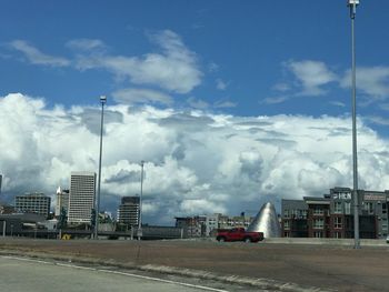 Road by street against sky in city