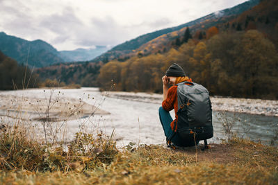 Man standing on mountain against sky