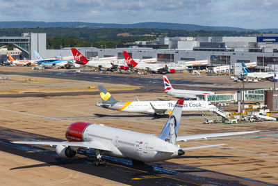 High angle view of airplane on airport runway against sky