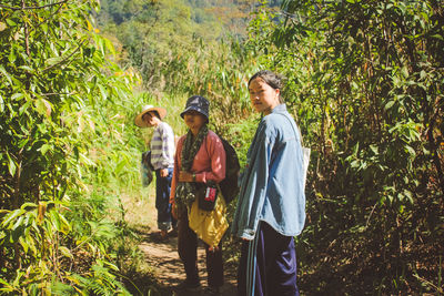 People standing by plants