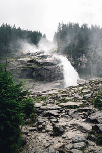 Scenic view of waterfall against clear sky in forest