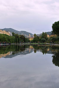 Scenic view of lake by trees against sky