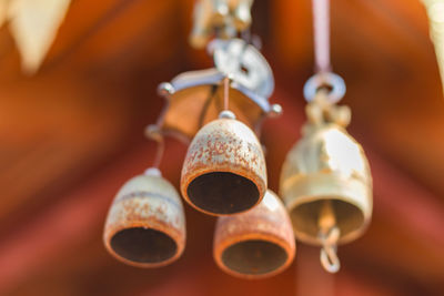 Close-up of electric lamp hanging in row