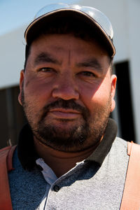 Close-up portrait of man in cap outdoors