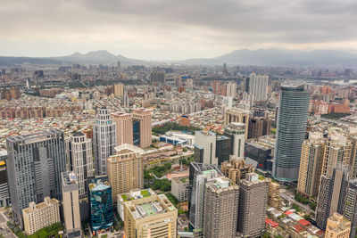 High angle view of modern buildings in city against sky