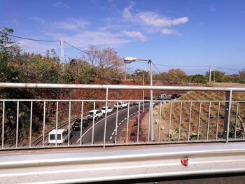 Footbridge over road against sky