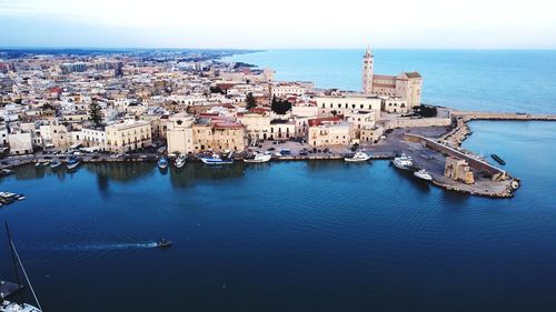 High angle view of townscape by sea against sky