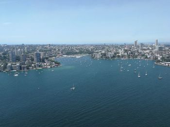 High angle view of buildings by sea against sky