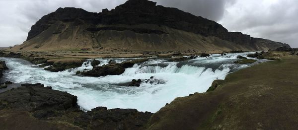 Panoramic shot of rocks in sea against sky