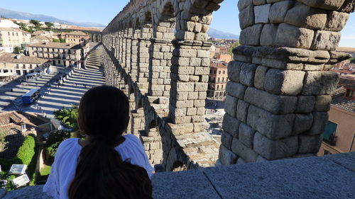 Rear view of girl looking at ancient built structure