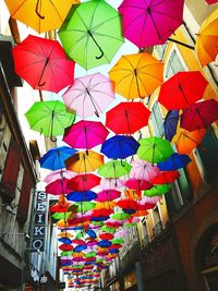 Low angle view of multi colored umbrellas hanging at market stall